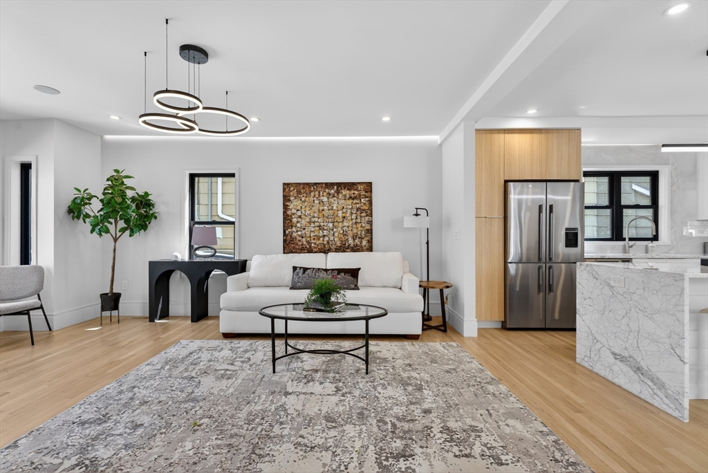 29 Line Street Cambridge, MA 02138 - Photo 4 of 42 a living room with furniture and a chandelier