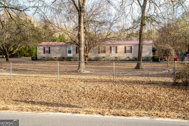 a view of a house with a yard covered in snow