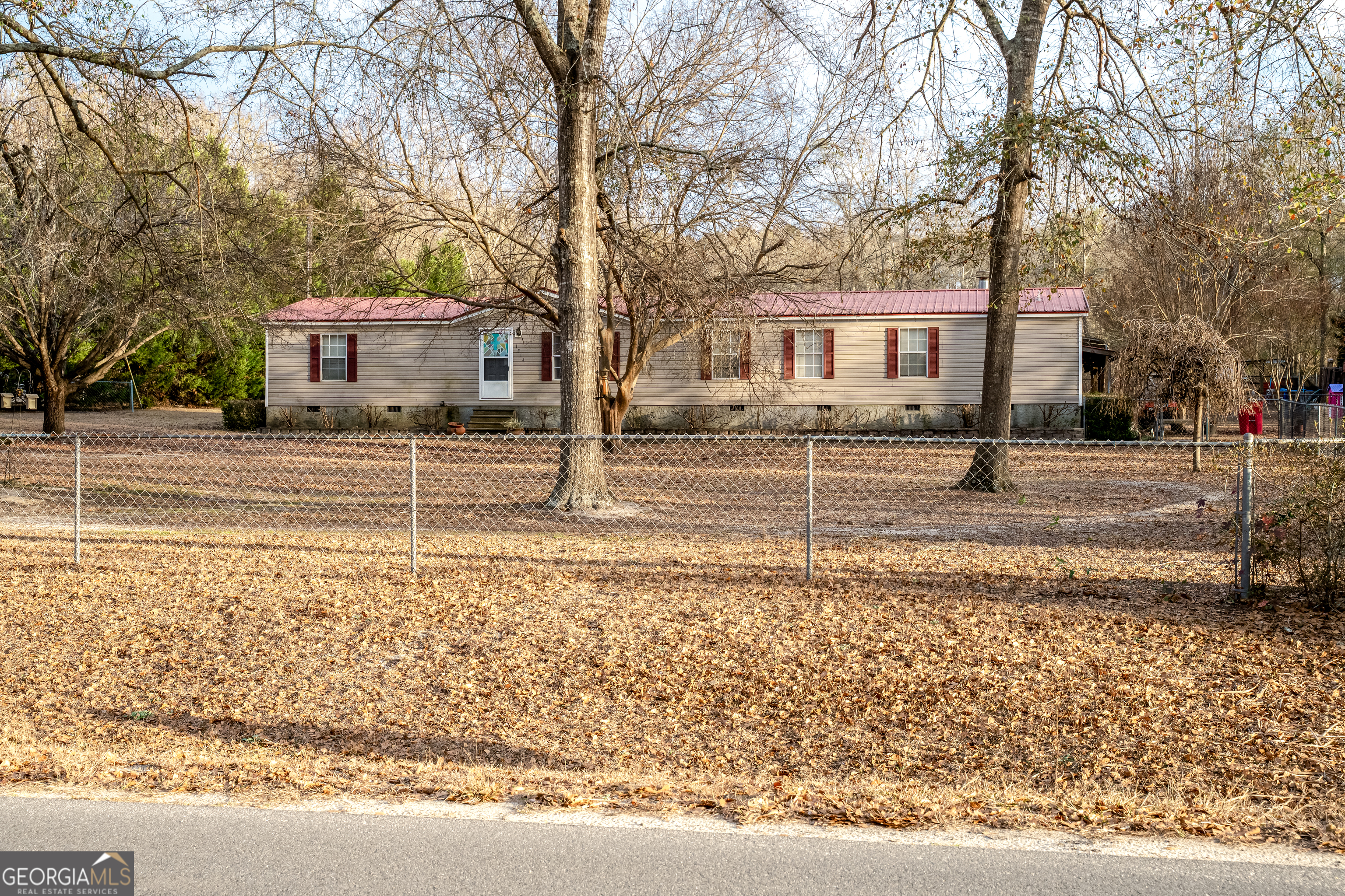a view of a house with a yard covered in snow
