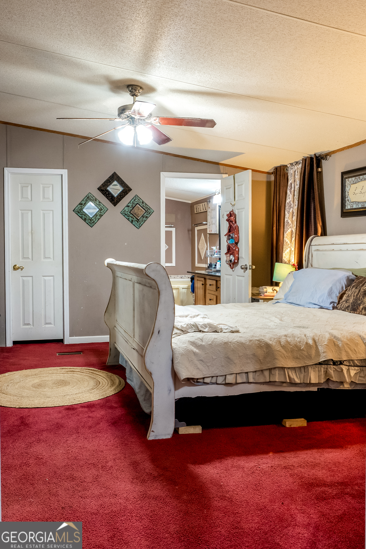 1214 Holiday S Drive Rentz, GA 31075 - Photo 13 of 19 a bedroom with a large bed and a chandelier
