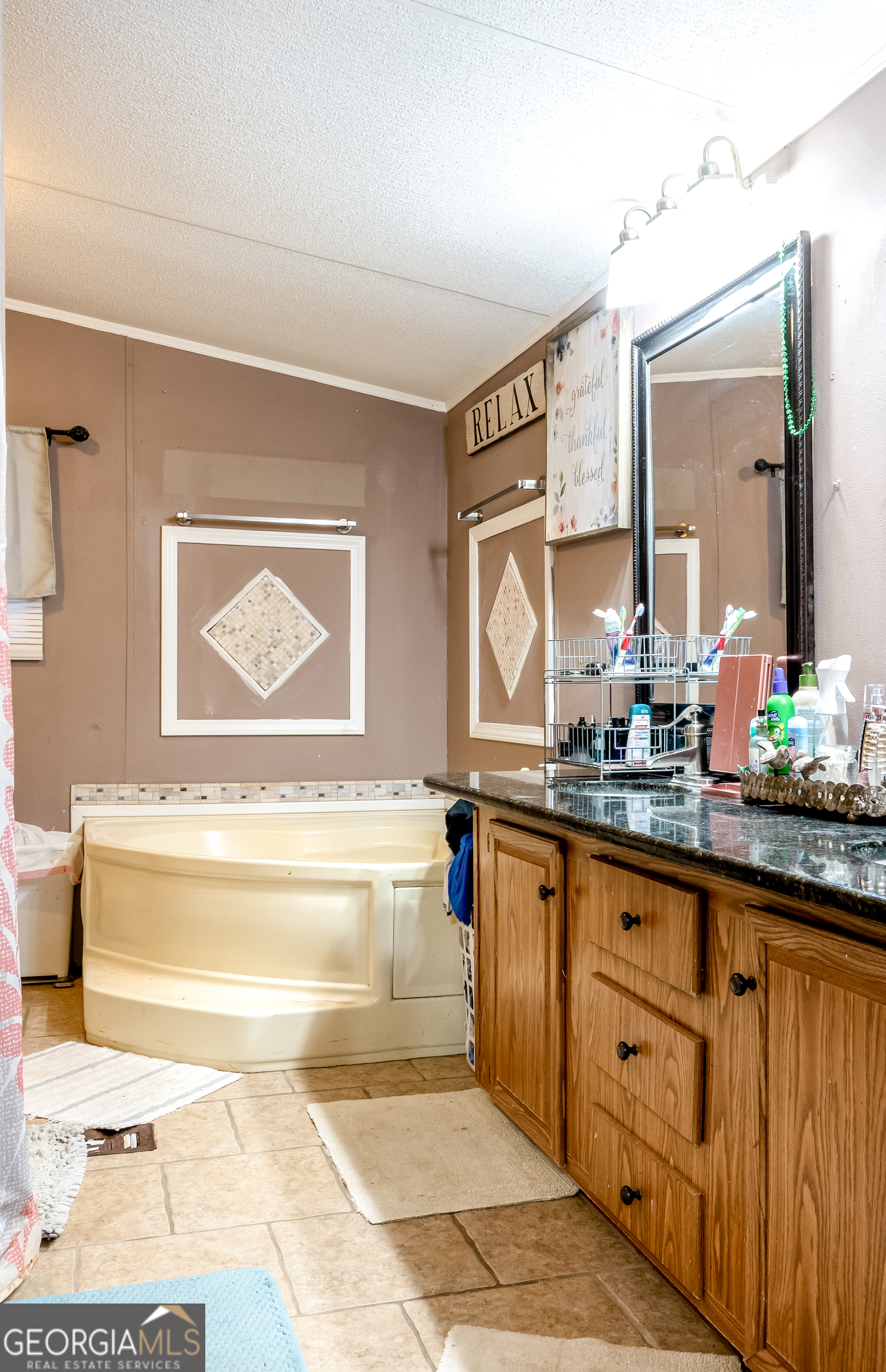 1214 Holiday S Drive Rentz, GA 31075 - Photo 14 of 19 a bathroom with a tub sink and mirror