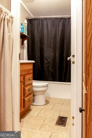 a bathroom with a toilet a sink and shower