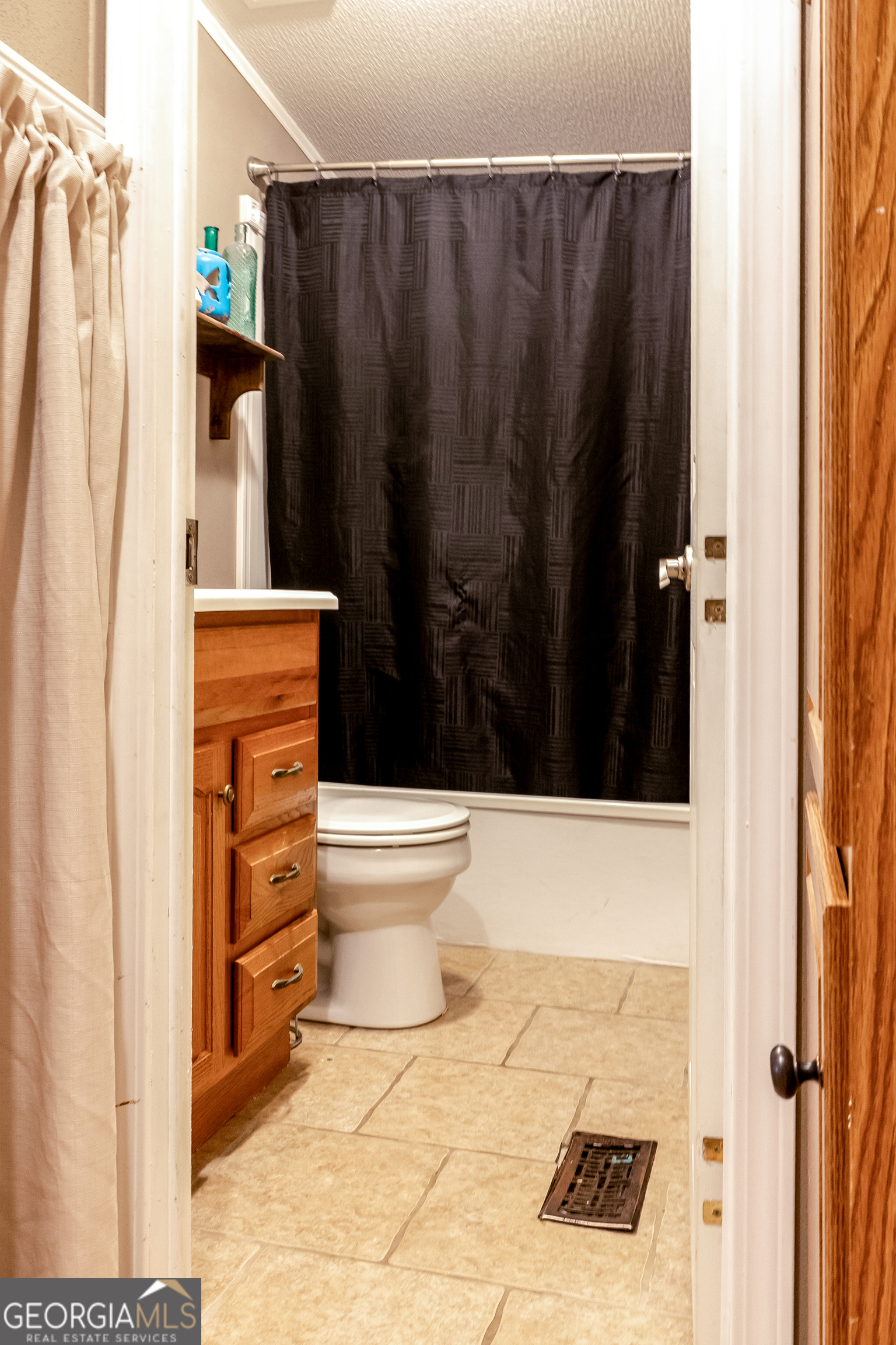 1214 Holiday S Drive Rentz, GA 31075 - Photo 18 of 19 a bathroom with a toilet a sink and shower