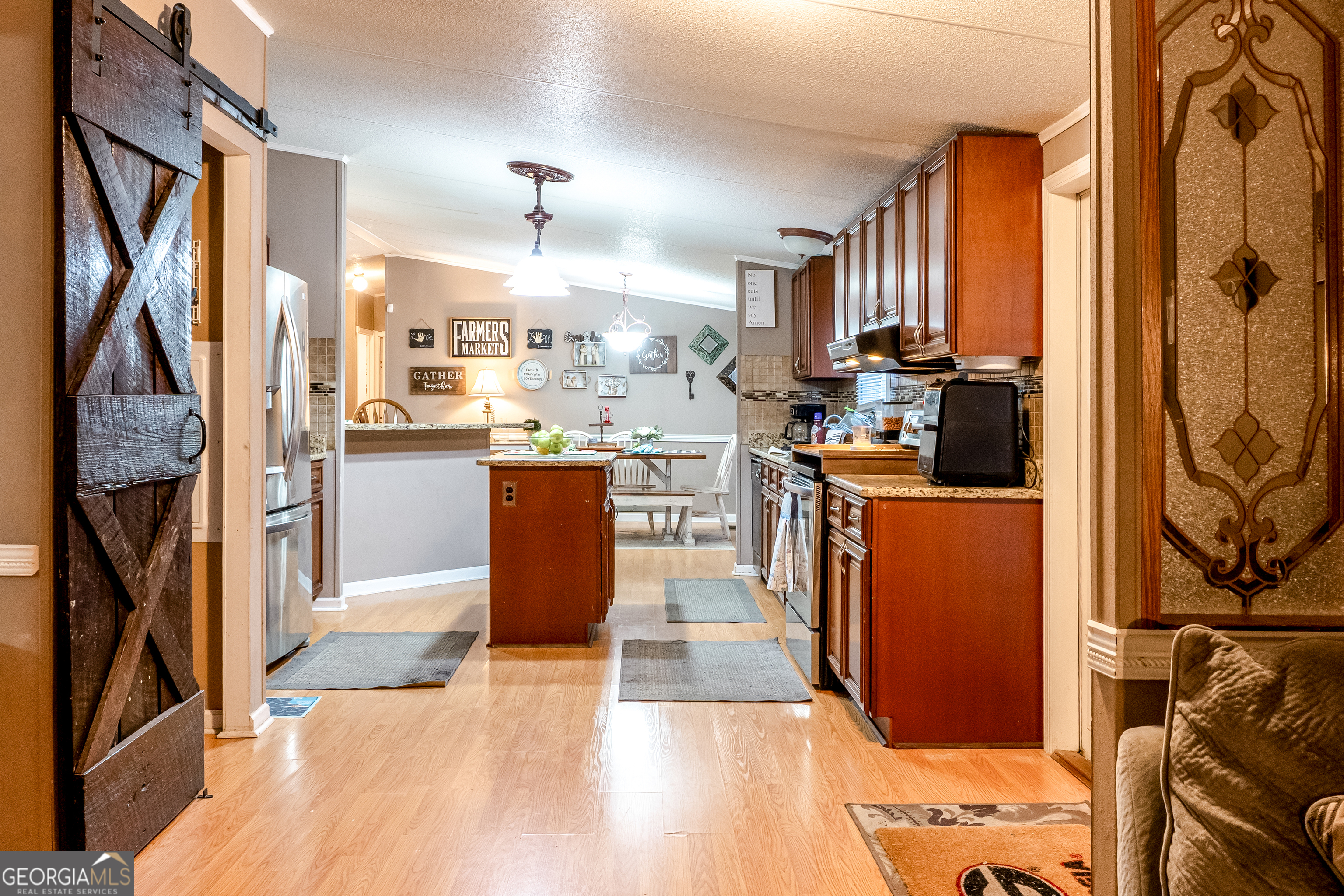 1214 Holiday S Drive Rentz, GA 31075 - Photo 6 of 19 a kitchen with stainless steel appliances granite countertop a refrigerator a stove top oven a sink and dishwasher