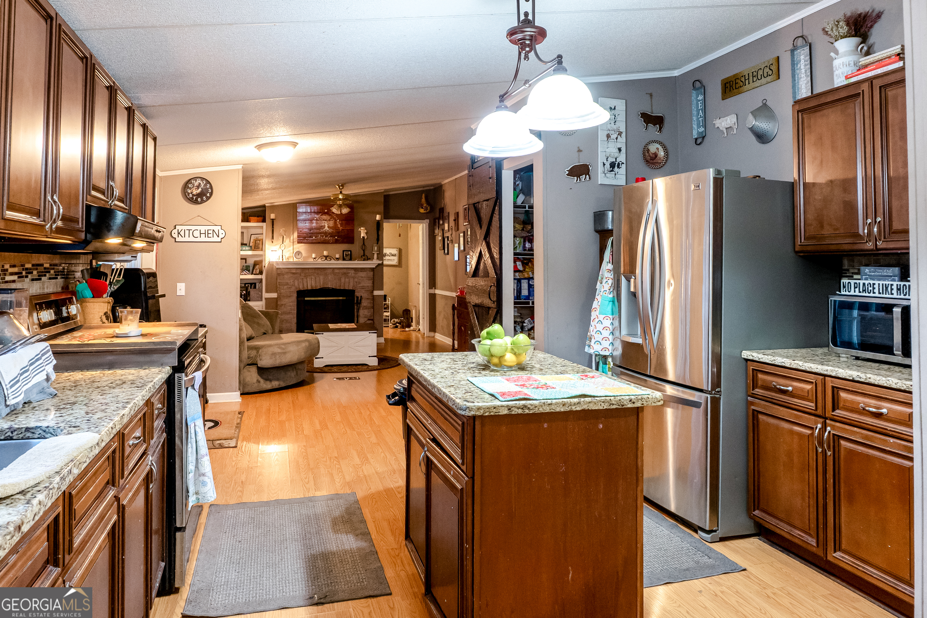 1214 Holiday S Drive Rentz, GA 31075 - Photo 7 of 19 a kitchen with stainless steel appliances granite countertop a sink stove and refrigerator