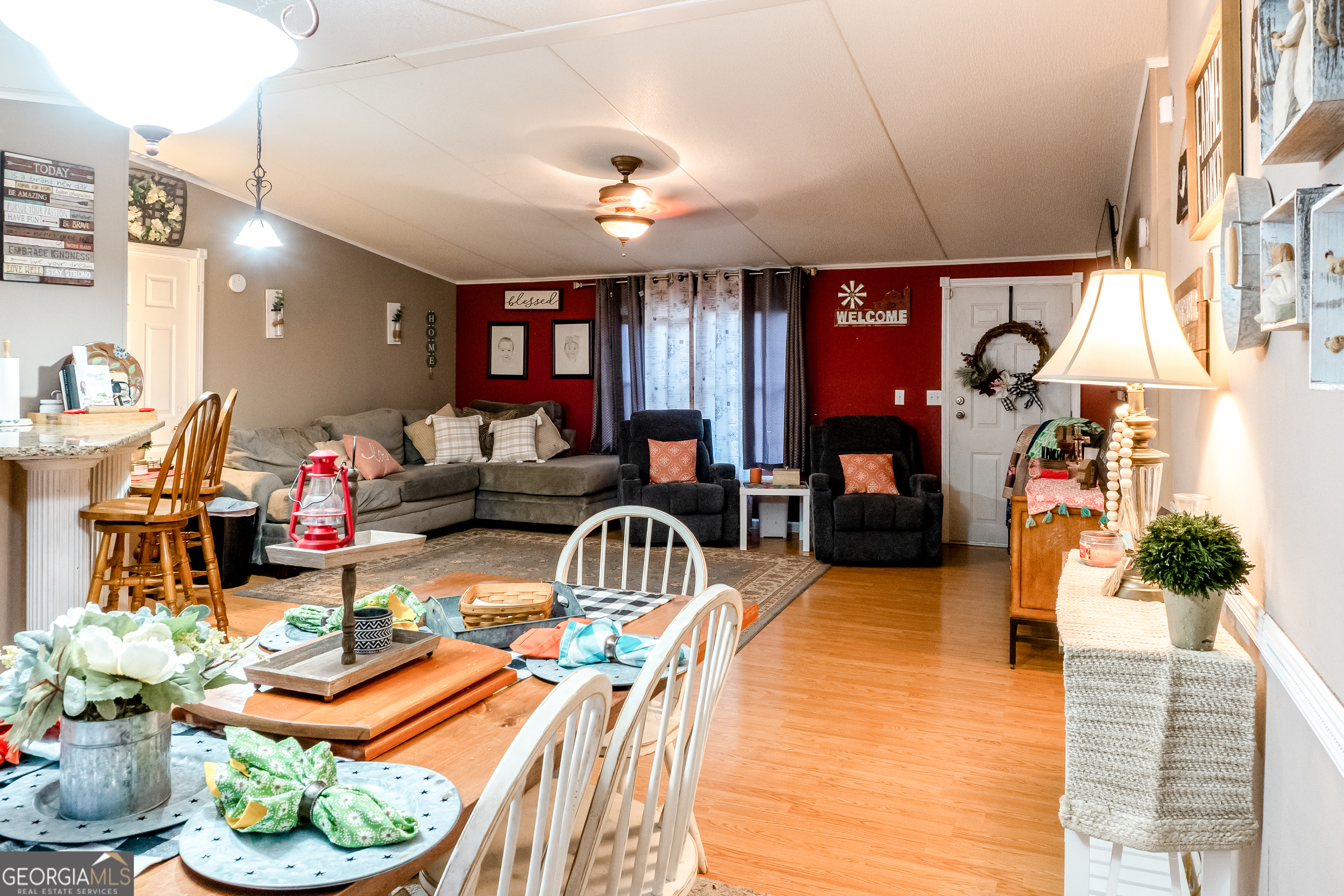 1214 Holiday S Drive Rentz, GA 31075 - Photo 9 of 19 a living room with furniture a chandelier and living room view
