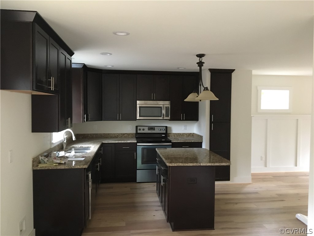 3936 Wood Dale Road Chester, VA 23831 - Photo 14 of 34 a kitchen with granite countertop stainless steel appliances and wooden cabinets