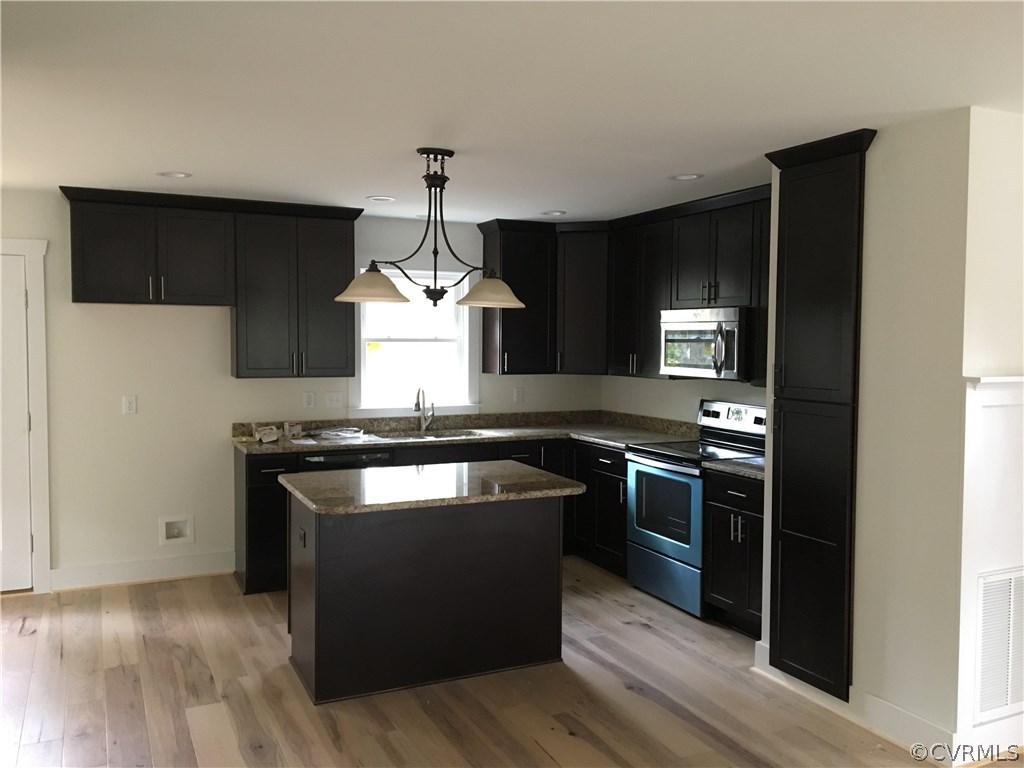 3936 Wood Dale Road Chester, VA 23831 - Photo 15 of 34 a kitchen with stainless steel appliances granite countertop a stove and a sink