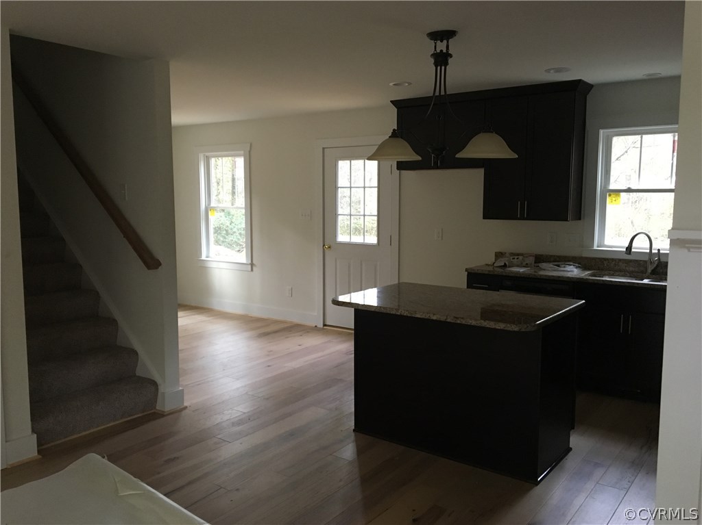 3936 Wood Dale Road Chester, VA 23831 - Photo 16 of 34 a kitchen with granite countertop a sink cabinets and a wooden floor