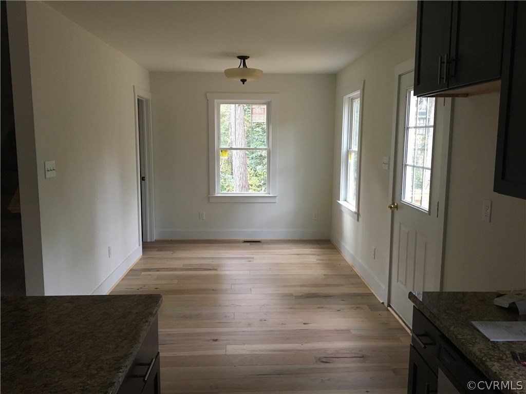 3936 Wood Dale Road Chester, VA 23831 - Photo 17 of 34 a view of an empty room with wooden floor and a window