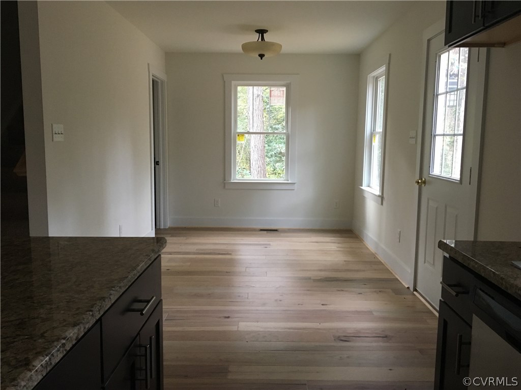3936 Wood Dale Road Chester, VA 23831 - Photo 18 of 34 a view of an empty room with wooden floor and a window