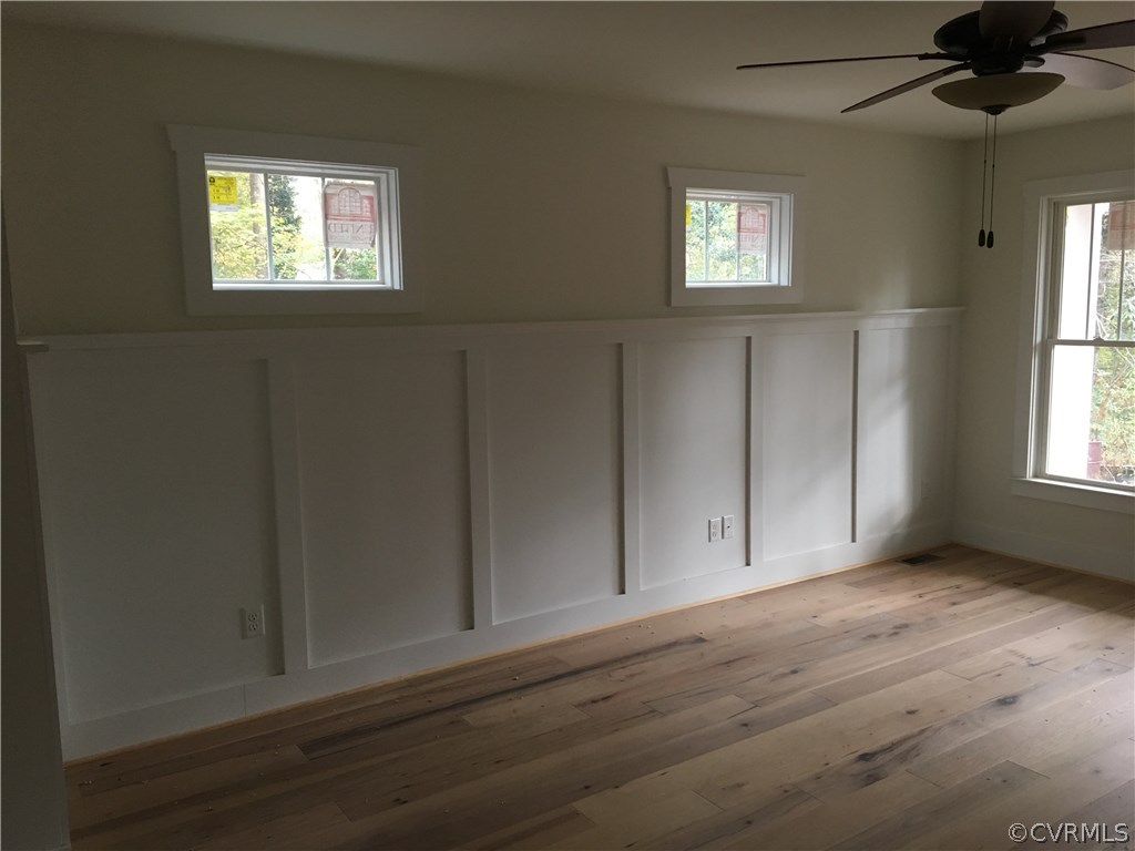 3936 Wood Dale Road Chester, VA 23831 - Photo 9 of 34 an empty room with wooden floor and windows