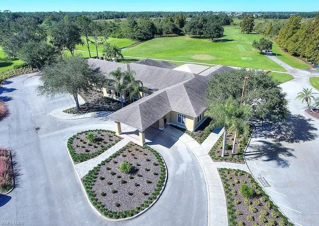 an aerial view of a house with outdoor space and lake view in back