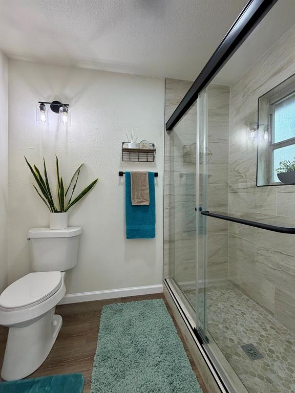 3609 Country Club Road Arlington, TX 76013 - Photo 26 of 40 a bathroom with a toilet and a shower