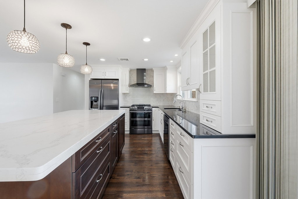 20 Mulhall Drive Ashland, MA 01721 - Photo 5 of 36 a kitchen with kitchen island a stove a sink and a refrigerator