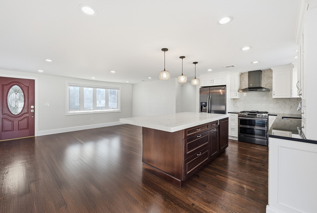 20 Mulhall Drive Ashland, MA 01721 - Photo 6 of 36 a kitchen with wooden floors and white cabinets