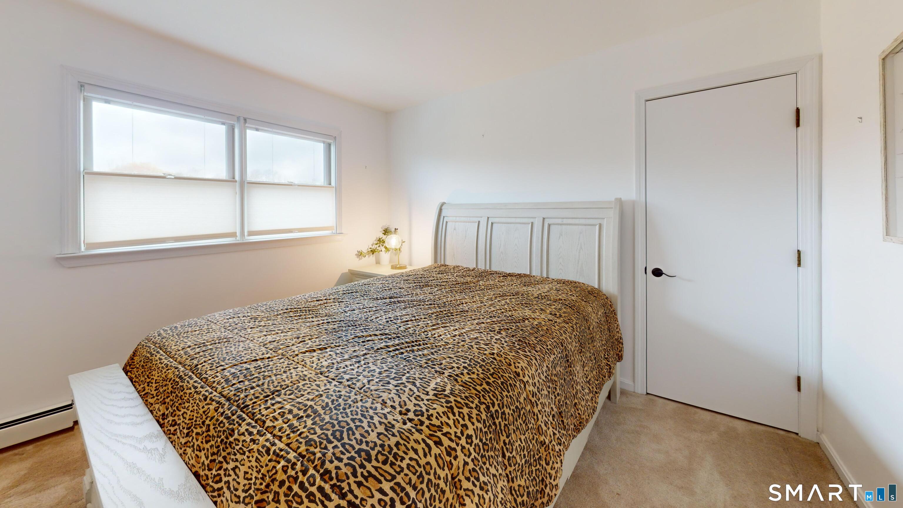 29 Deer Ridge Road Stonington, CT 06378 - Photo 18 of 35 a bedroom with a bed and a window