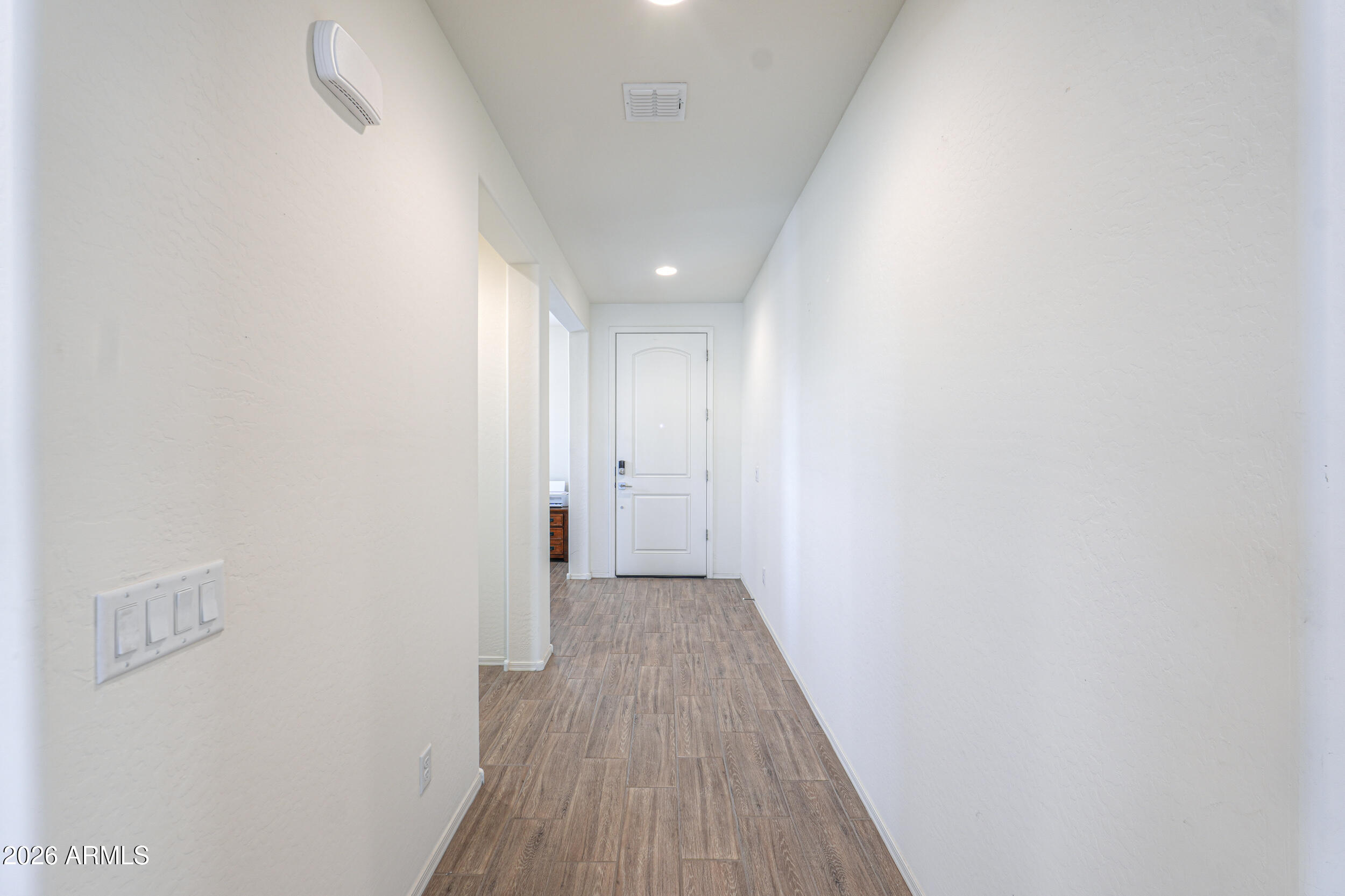 42085 West Cribbage Road Maricopa, AZ 85138 - Photo 7 of 35 a view of a hallway with wooden floor