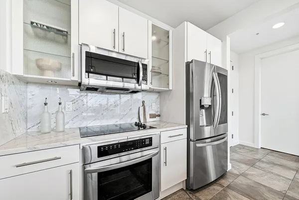 a kitchen with stainless steel appliances a refrigerator stove and microwave