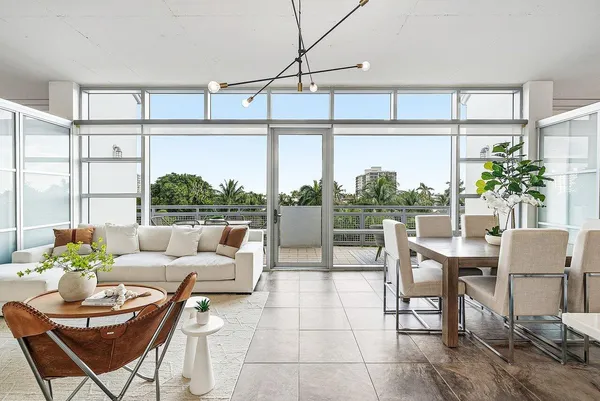 a living room with furniture and a potted plant
