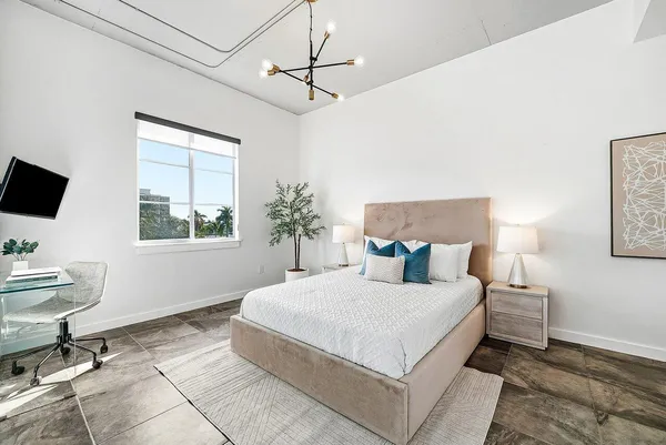 a bedroom with a large bed and a window