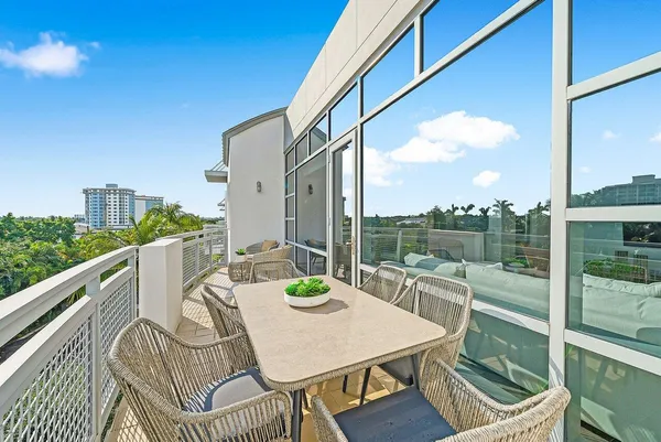 a view of a balcony with table and chairs
