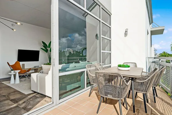 a view of an outdoor dining space with a table and chairs