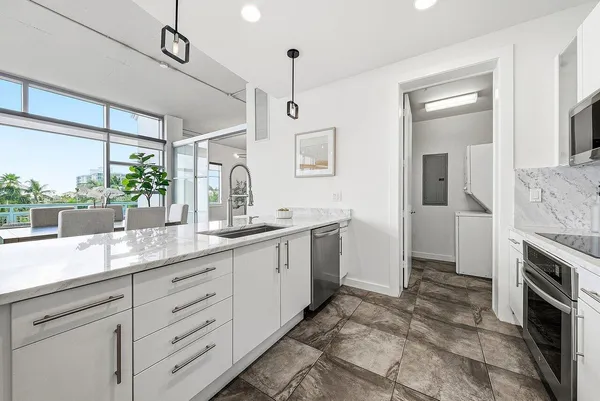 a spacious bathroom with a granite countertop sink mirror and vanity