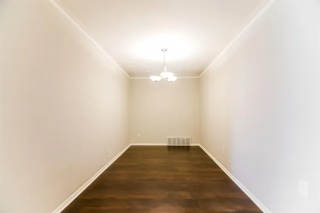 a view of a room with wooden floor and ceiling fan