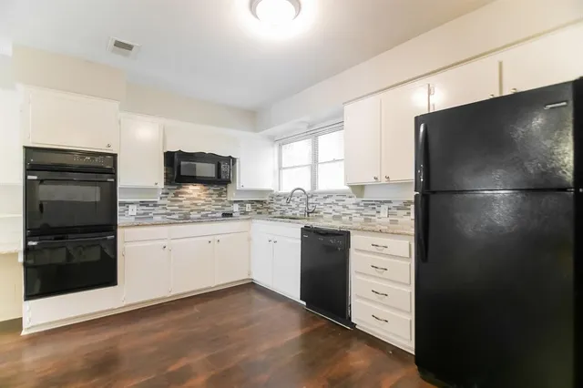 a kitchen with a refrigerator stove and sink