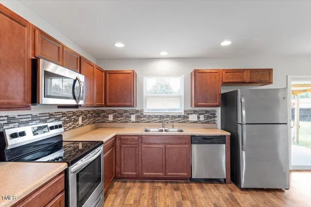 a kitchen with a stove a sink and a refrigerator