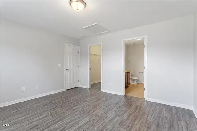 a view of a room with wooden floor