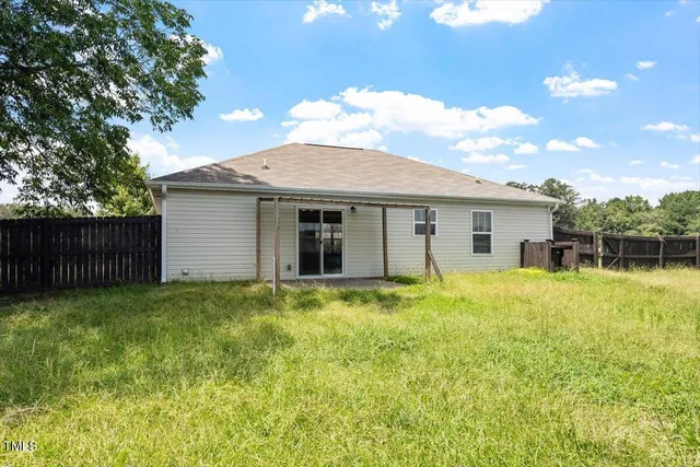 a backyard of a house with yard and barbeque oven