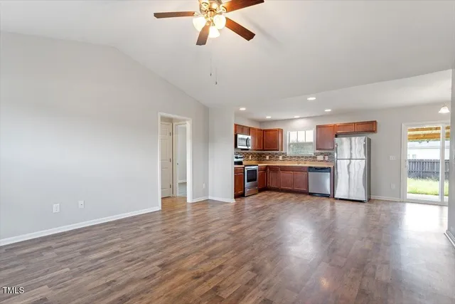 a view of kitchen with kitchen island wooden floor and ceiling fan