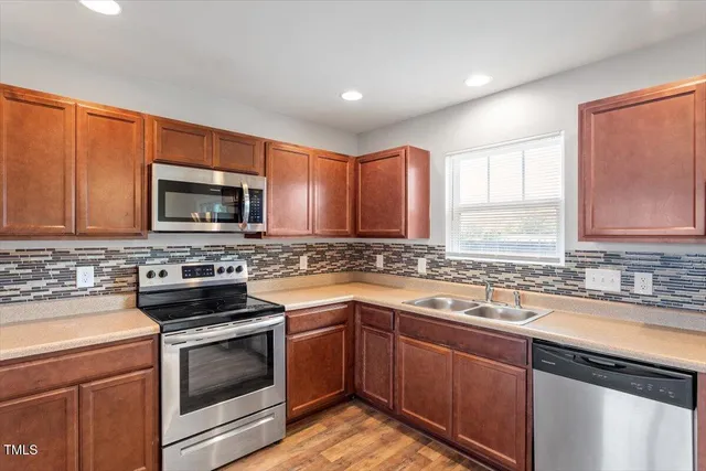 a kitchen with a sink stove and microwave