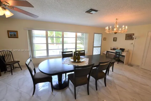 a view of a dining room with furniture and window