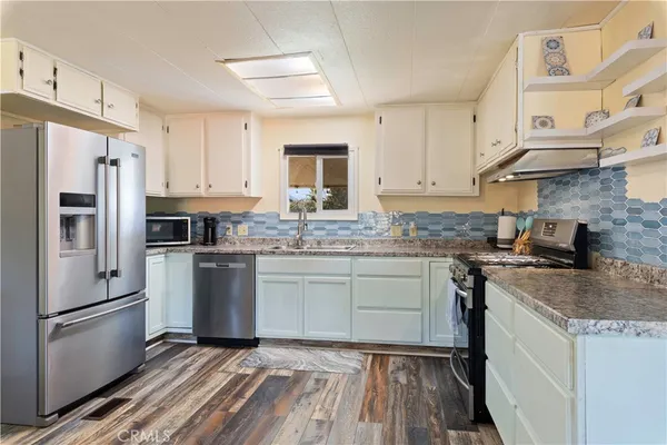 a kitchen with a sink stove and cabinets