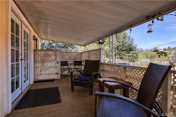 a view of a chairs and table in the balcony