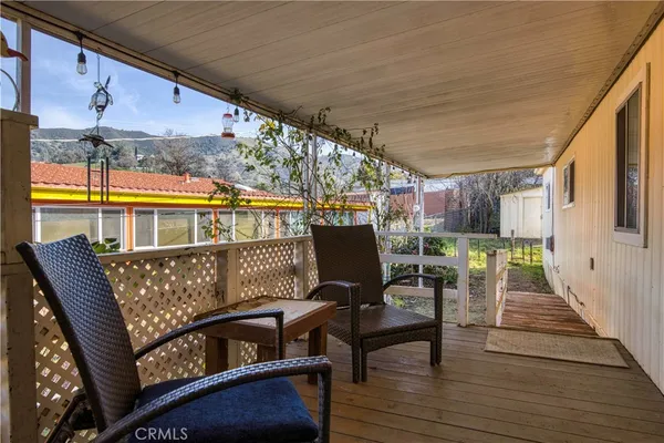 a balcony with wooden floor and fence