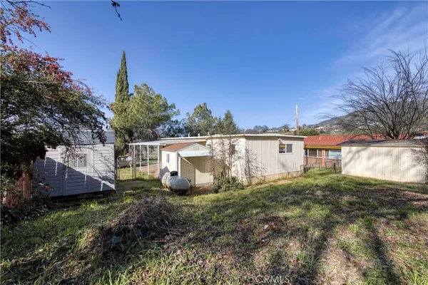a view of a chair and table and potted on the side of the house