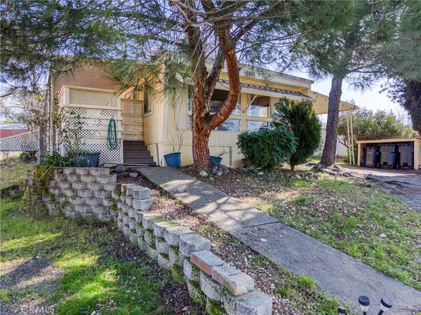 a living room with furniture a flat screen tv and a large window