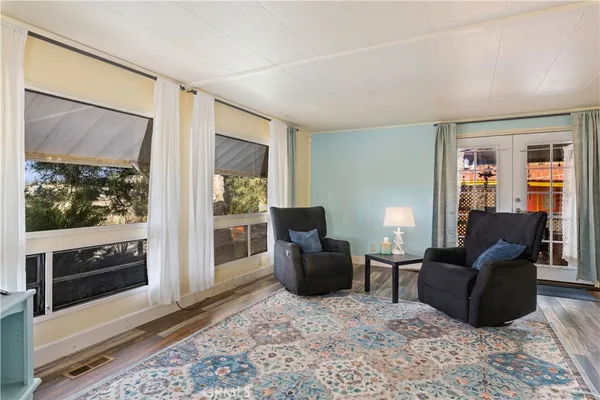 a living room with furniture wooden floor and a window