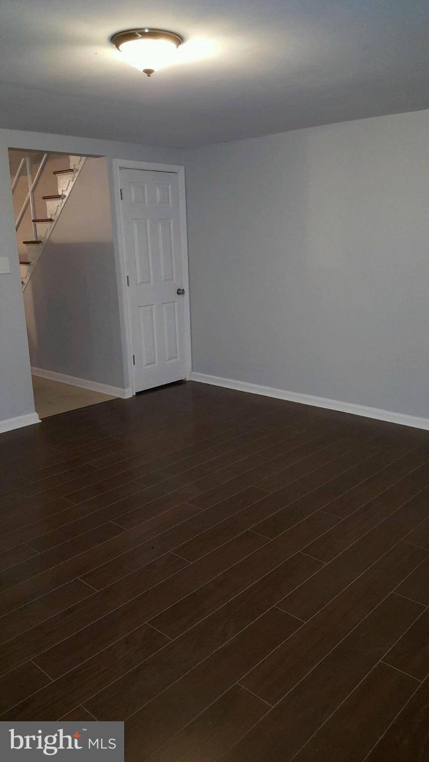 3304 Bero Road Baltimore, MD 21227 - Photo 13 of 27 a view of an empty room with wooden floor and a window
