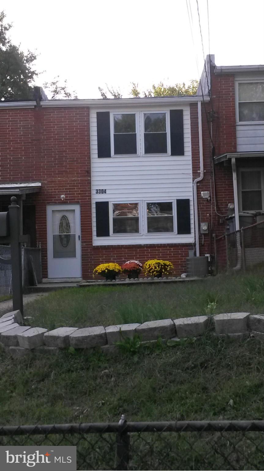 3304 Bero Road Baltimore, MD 21227 - Photo 17 of 27 a front view of a house with a yard
