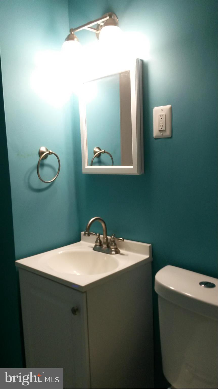 3304 Bero Road Baltimore, MD 21227 - Photo 19 of 27 a bathroom with a sink mirror and toilet