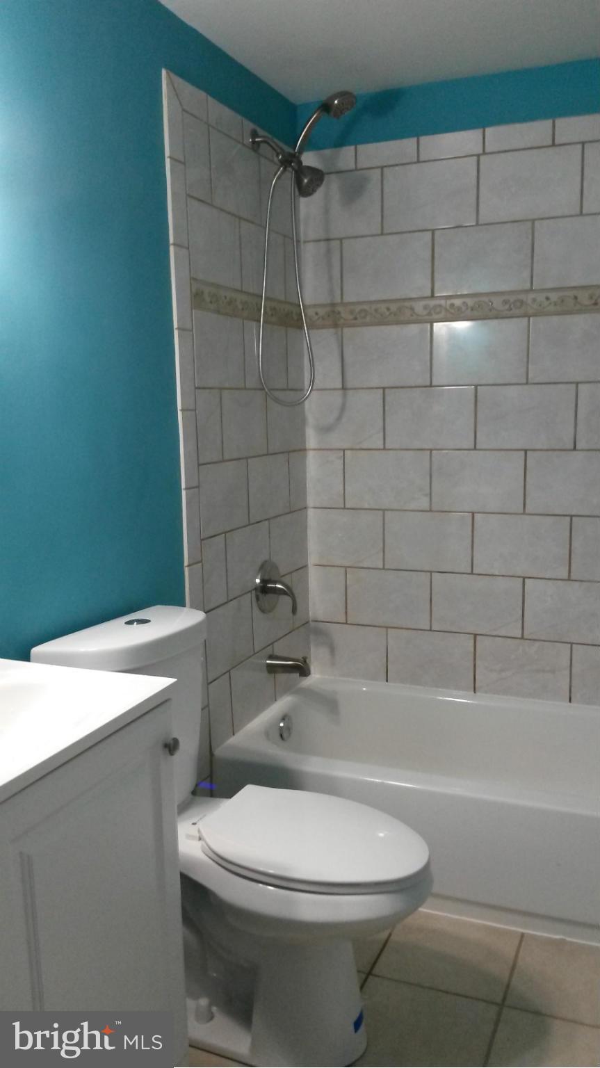 3304 Bero Road Baltimore, MD 21227 - Photo 20 of 27 a white toilet sitting next to a bath tub