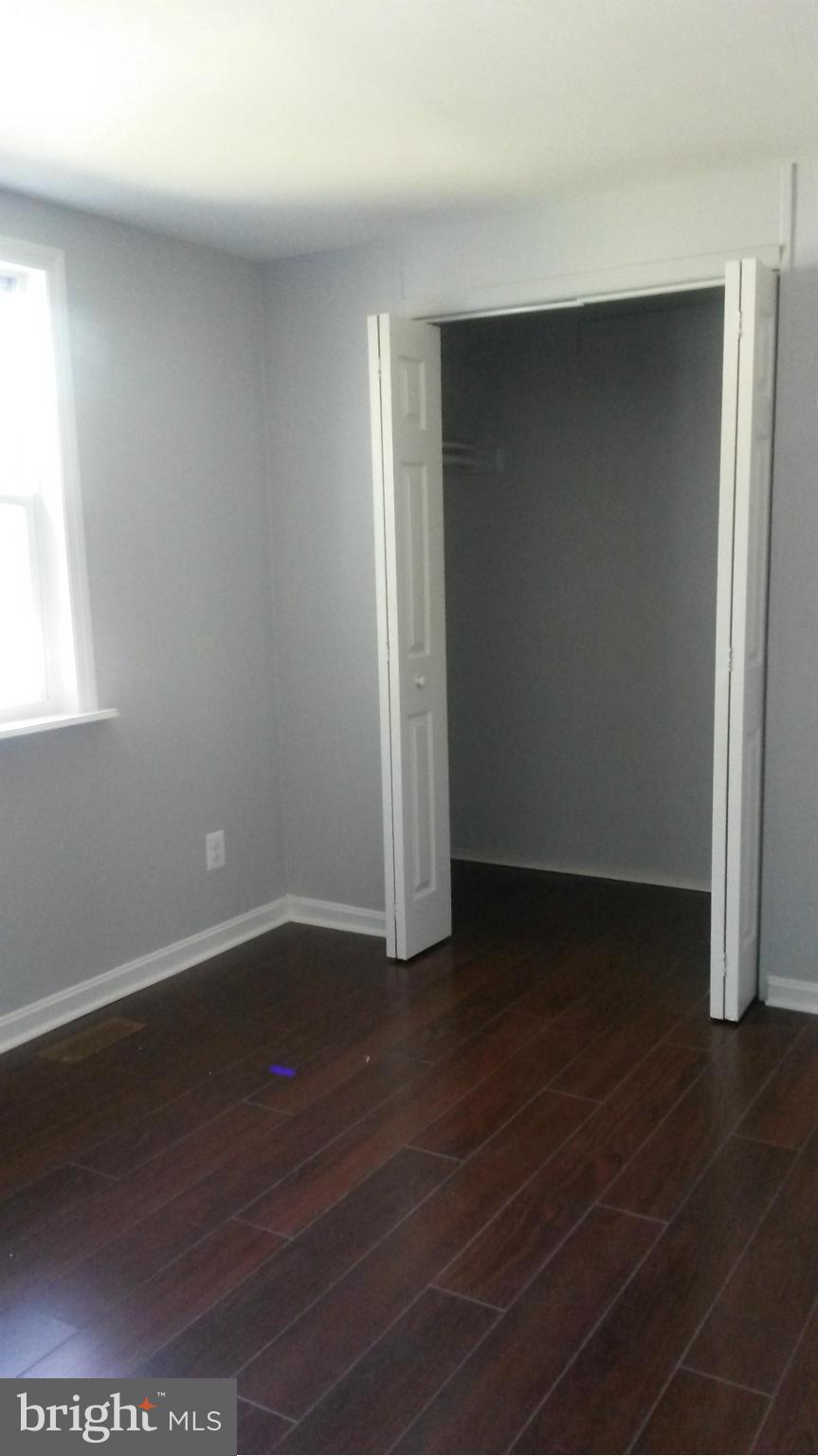 3304 Bero Road Baltimore, MD 21227 - Photo 23 of 27 an empty room with wooden floor and windows