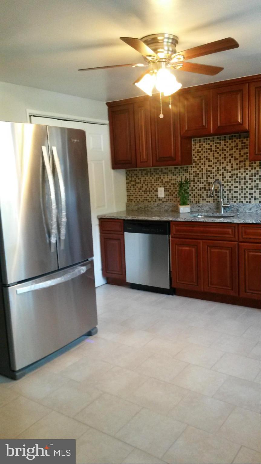 3304 Bero Road Baltimore, MD 21227 - Photo 5 of 27 a kitchen with stainless steel appliances granite countertop a sink and a refrigerator