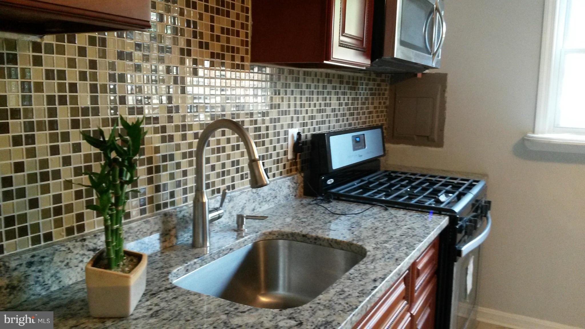 3304 Bero Road Baltimore, MD 21227 - Photo 6 of 27 a kitchen view of a sink and a stove