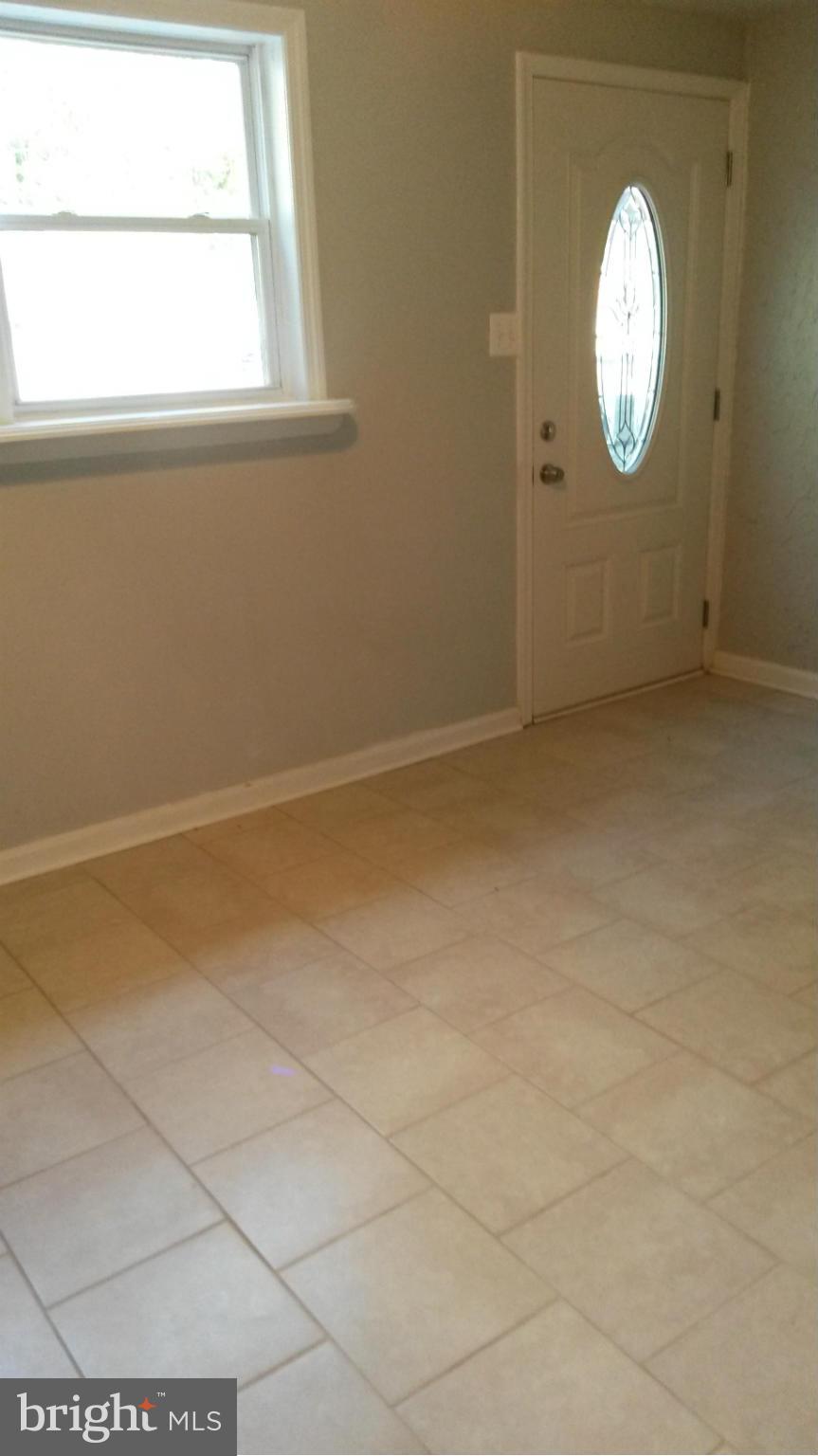 3304 Bero Road Baltimore, MD 21227 - Photo 8 of 27 a view of a livingroom with wooden floor and a window